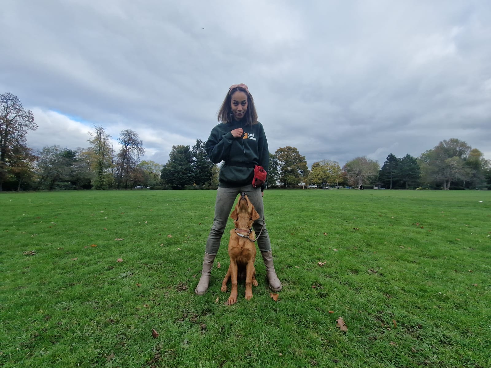 Gala practising positive reinforcement with a dog on grass